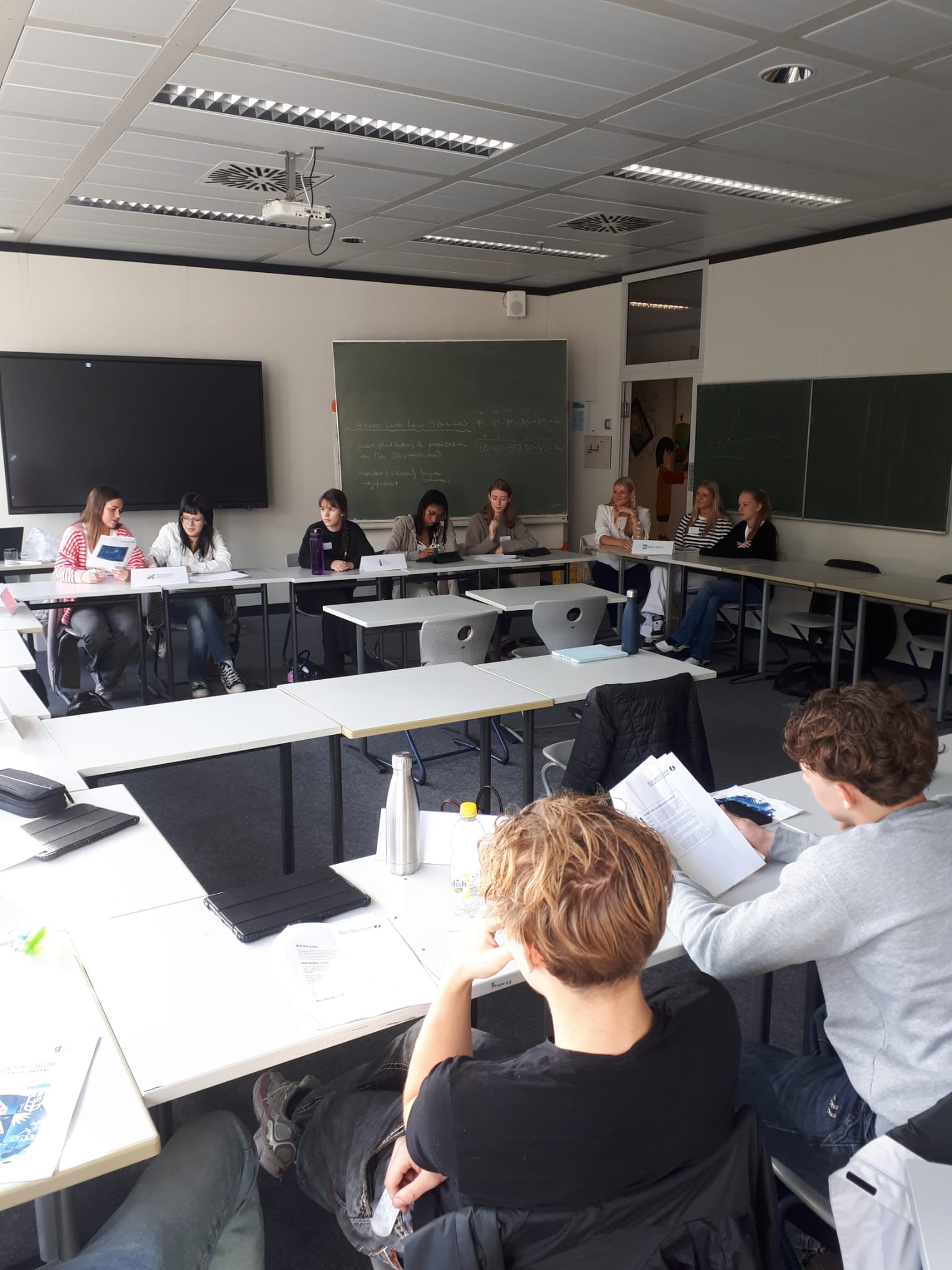 Die Schülerinnen und Schüler des Geographie-Profils sitzen in einer Runde und diskutieren intensiv miteinander